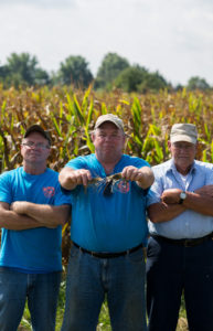  Don Maloney (middle) stands proudly holding two of his harvested prawns. Close friends Dana Wilder (left) and Jay Picklesimer (right) help Maloney with the harvesting. 