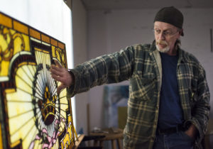 Bernie Evans shows his passion for the art as he explains the detail in this stained glass piece.
