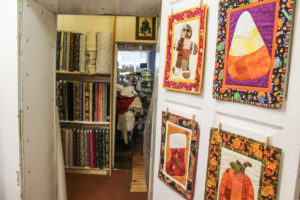 The shop boasts a multiple of rooms, all filled with shelves of material.
